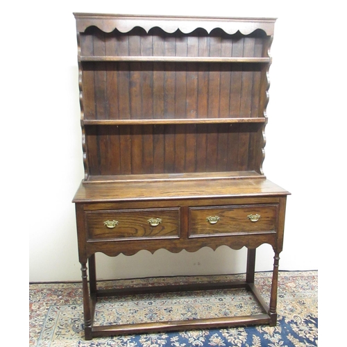 335 - Oak cottage type dresser with two shelf raised back, base with two drawers on turned supports with s... 