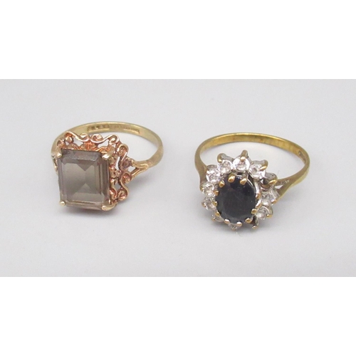 853 - 9ct yellow gold ring set with central sapphire surrounded by clear stones, size O1/2, and a 9ct gold... 