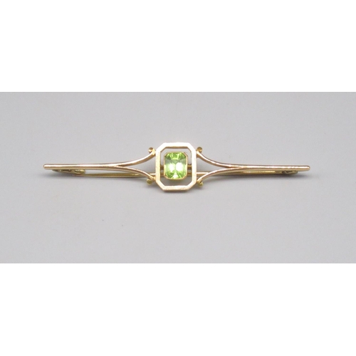 858 - 15ct yellow gold bar brooch set with emerald cut peridot, stamped 15ct, 4.3g