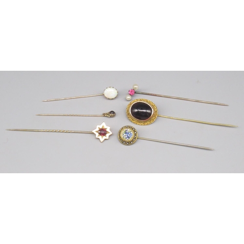 862 - Collection on unmarked yellow metal tie pins set with various stones, including one micro mosaic, an... 