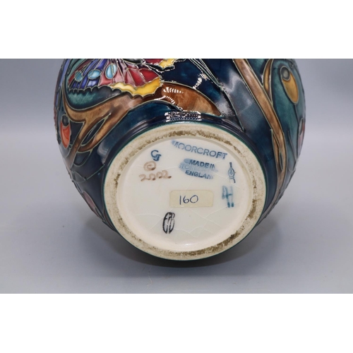 214 - Moorcroft Pottery: Harting pattern jar and cover, decorated with flowers, butterflies, berries, and ... 