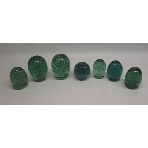 84 - Group of seven green glass dumps, four with internal flowers, max H13cm. a/f