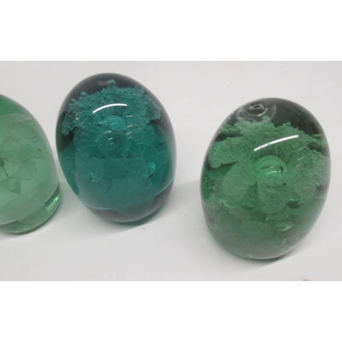 84 - Group of seven green glass dumps, four with internal flowers, max H13cm. a/f