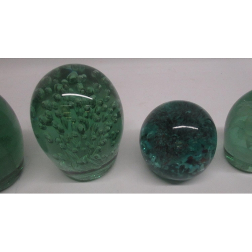 84 - Group of seven green glass dumps, four with internal flowers, max H13cm. a/f