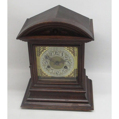 680 - Junghans - early C20th oak arched top mantle clock, bevelled glazed panel door enclosing brass dial ... 