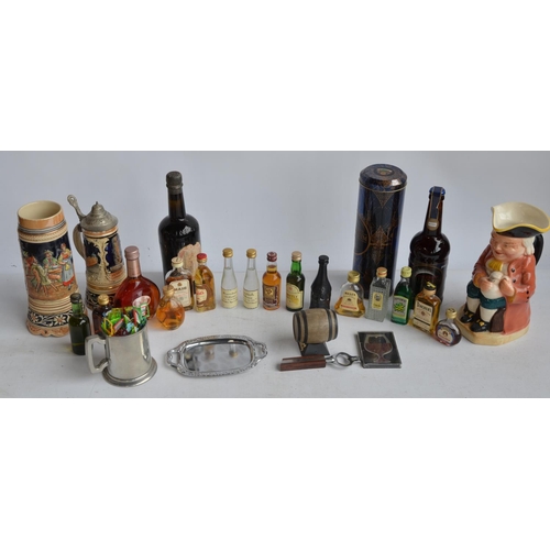 702 - Collection of miniature bottles of spirits to include various whisky's, Cointreau etc, a bottle of M... 