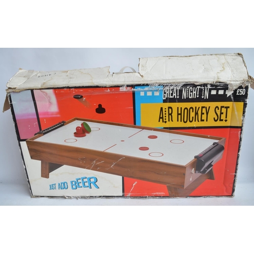 711 - Boxed mains powered table top air hockey game in full working order.