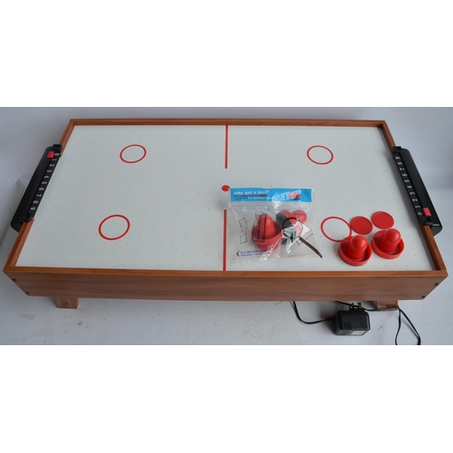 711 - Boxed mains powered table top air hockey game in full working order.