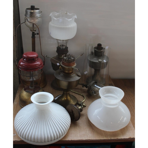 786 - Set of six oil and Tilly lamps of various types, including chimney's and student shades.