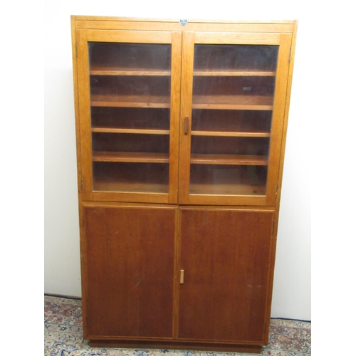 182 - C20th light oak bookcase with two glazed and two panel doors, W108cm D30cm H188cm