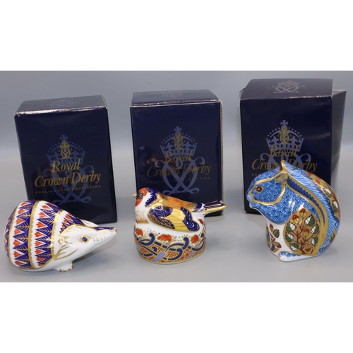 363 - Three Royal Crown Derby paperweights: Debenhams Squirrel, Nesting Goldfinch, and Hedgehog, with boxe... 