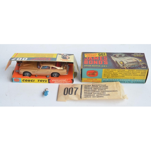 Corgi James Bond gold painted Aston Martin DB5 (261) with original box, insert, spare ejecting figure and secret instruction envelope. Car in good fully working condition with intact underside rivet but with added numberplate stickers (removable) and tax disc, box excellent for age.