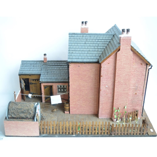 513 - Large charming home made wooden wartime house model with Anderson shelter. Includes removeable panel... 