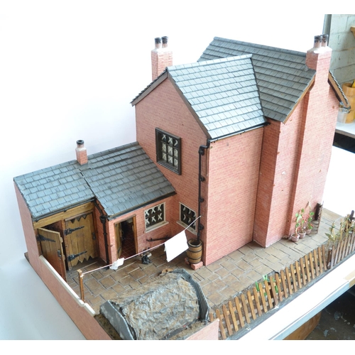 513 - Large charming home made wooden wartime house model with Anderson shelter. Includes removeable panel... 