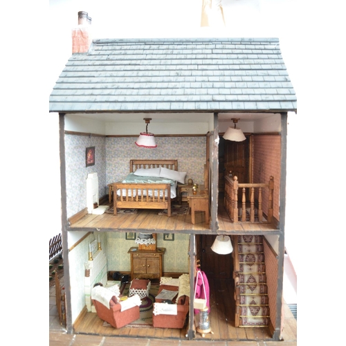 513 - Large charming home made wooden wartime house model with Anderson shelter. Includes removeable panel... 