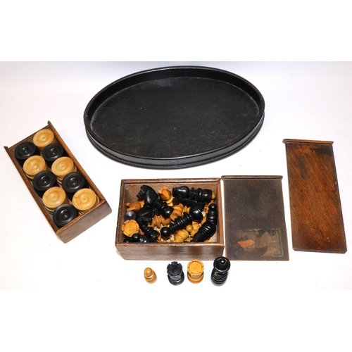 191 - Set of early C20th chess pieces and a set of draughts, both complete and boxed, and an oval dressing... 