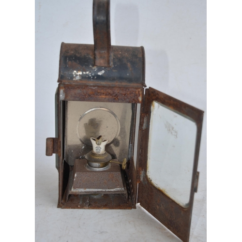 624 - Two vintage railway lamps to include a BR(M) railwayman's lamp with slatted red, green and blue glas... 