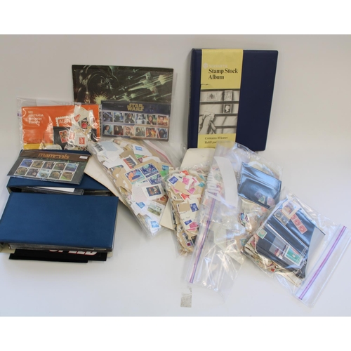 325 - Two albums of FDCs, bagged loose stamps and a stock album of mostly MNH commemorative GB stamps etc.