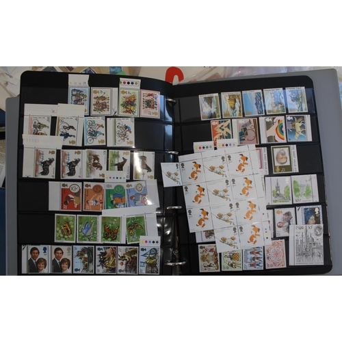 325 - Two albums of FDCs, bagged loose stamps and a stock album of mostly MNH commemorative GB stamps etc.