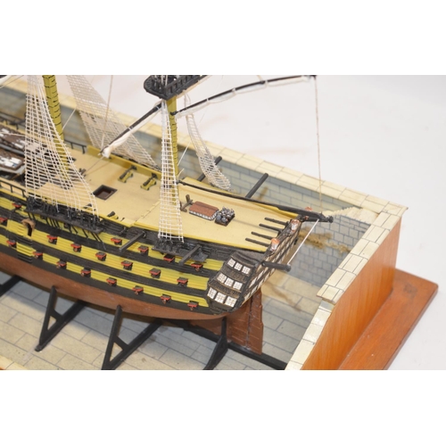 89 - Built up plastic kit (likely 1/180 scale Airfix) of HMS Victory in dry dock with diorama setting com... 