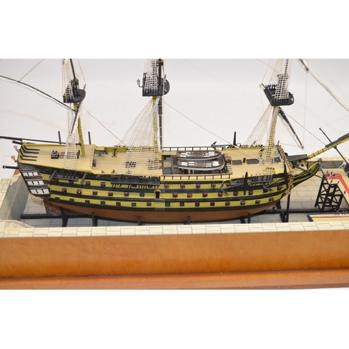 89 - Built up plastic kit (likely 1/180 scale Airfix) of HMS Victory in dry dock with diorama setting com... 