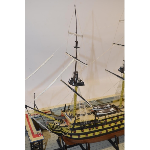 89 - Built up plastic kit (likely 1/180 scale Airfix) of HMS Victory in dry dock with diorama setting com... 