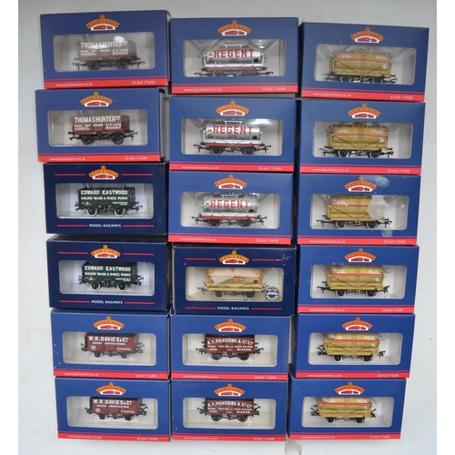 570A - Eighteen Bachmann OO gauge railway wagons to include 7 plank end door wagons, 14 ton tank wagons etc... 