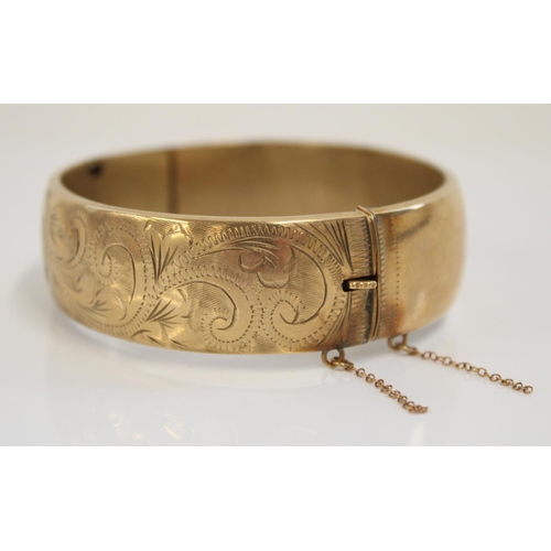 1234 - Hallmarked 9ct gold bangle, front engraved with scrolls and leaves pattern, internal width 6cm, 22.4... 