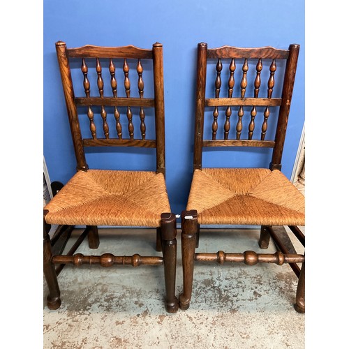 175 - Set of six elm bobbin back rush seat dining chairs, on turned supports with stretchers and pad feet,... 