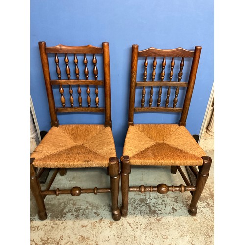 175 - Set of six elm bobbin back rush seat dining chairs, on turned supports with stretchers and pad feet,... 