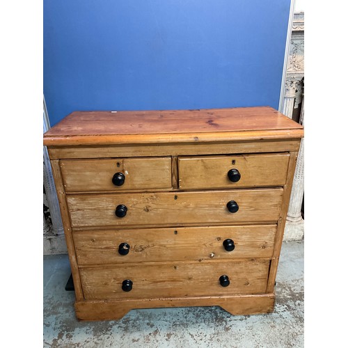 169 - Victorian waxed pine chest of two short and three long drawers with turned ebonised handles on skirt... 