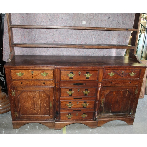 1422 - George 1V oak breakfront dresser, later three tier rack, with moulded cornice, the base with six dra... 