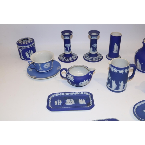 411 - Collection of Wedgwood dipped blue jasperware, incl. teapot, pair of candlesticks, four jugs, cup an... 