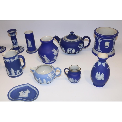 411 - Collection of Wedgwood dipped blue jasperware, incl. teapot, pair of candlesticks, four jugs, cup an... 