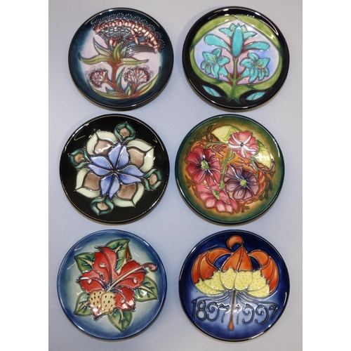 723 - Moorcroft Pottery: six pin dishes/coasters - 1897-1997 centenary; purple and pink flowers, 2001; red... 