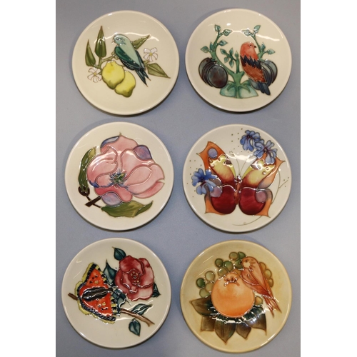 728 - Moorcroft Pottery: six pin dishes/coasters - finch with peach and berries, 1990; butterfly with flow... 