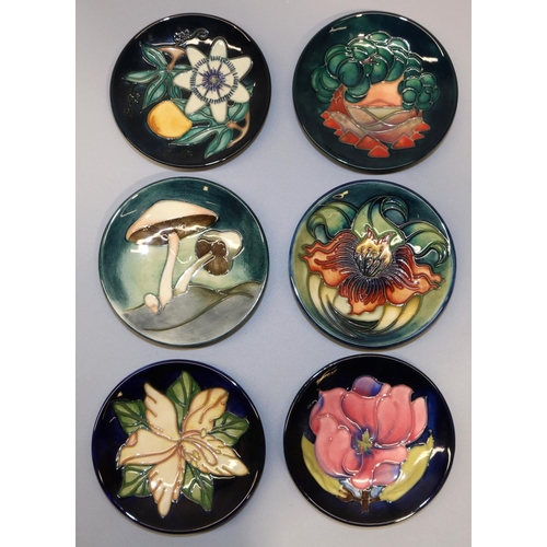 730 - Moorcroft Pottery: six pin dishes/coasters - pink magnolia on dark blue ground; 'Fairy Rings', cream... 