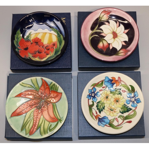 683 - Moorcroft Pottery: four trial pin dishes/coasters - red flower on green ground, dated '98; yellow an... 