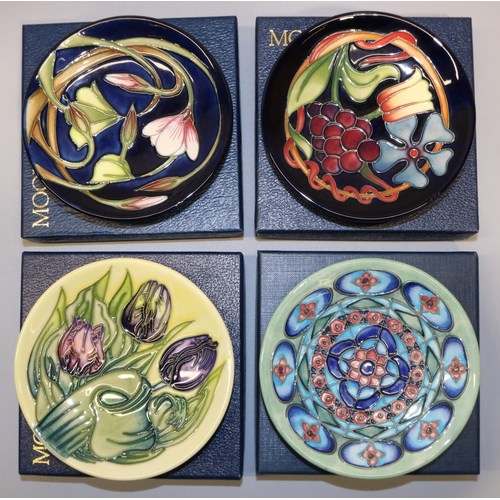 684 - Moorcroft Pottery: four trial pin dishes/coasters - vines and flowers on dark blue ground, dated '13... 