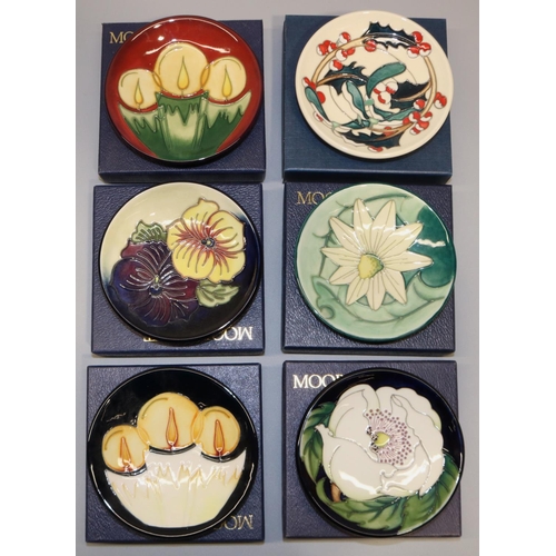 690 - Moorcroft Pottery: six trial pin dishes/coasters - white flower on dark blue ground, dated '22; two ... 