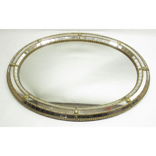 804 - Oval mirror with brass work segmented frame, W79cm x H60cm