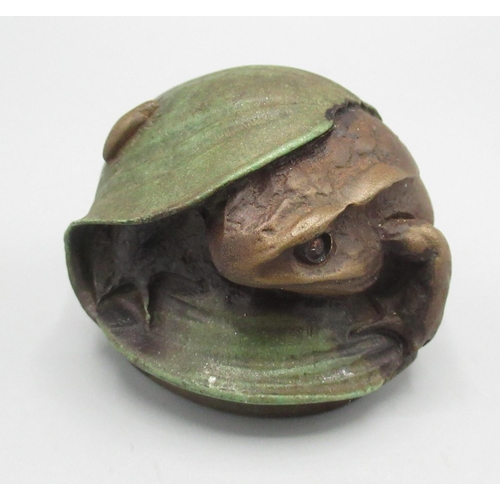 1274 - C20th Century Russian resin paperweight modelled as a frog sheltering beneath a leaf, marked beneath... 