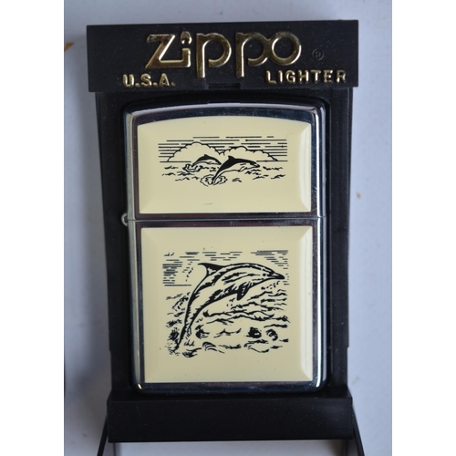 109 - Zippo 60th Anniversary and Scrimshaw Dolphins Zippo lighters in excellent little used condition with... 