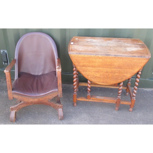 141 - C20th low open arm chair, on X frame supports and curved feet, and an oak oval gateleg table on barl... 
