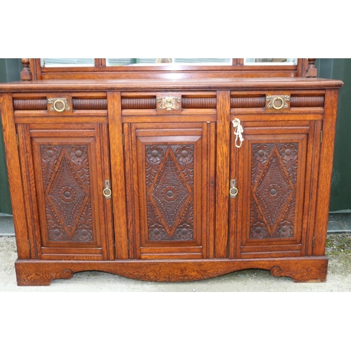 142 - Victorian oak mirror back sideboard, with arched cornice and three mirror plates above three drawers... 