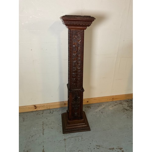 861 - Victorian oak square tapering pedestal, relief carved with trailing leafage and figures, on stepped ... 