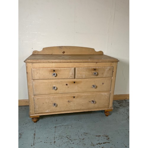 873 - Victorian stripped pine chest with raised back and two short and two long drawers with glass handles... 