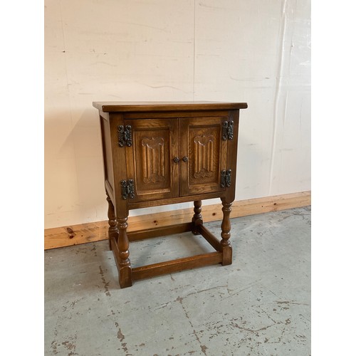 996 - Small oak bedside cabinet with two linenfold panel doors on baluster turned supports with stretchers... 