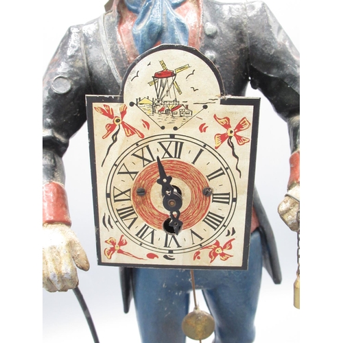 349 - C20th painted spelter table clock in the form of a Dutch peddler with arched dial fronting on shaped... 