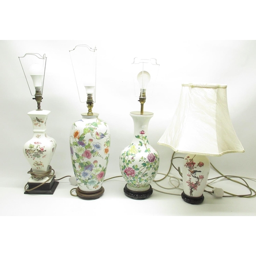 974 - Four white ceramic table lamps florally decorated with some songbirds, with shades